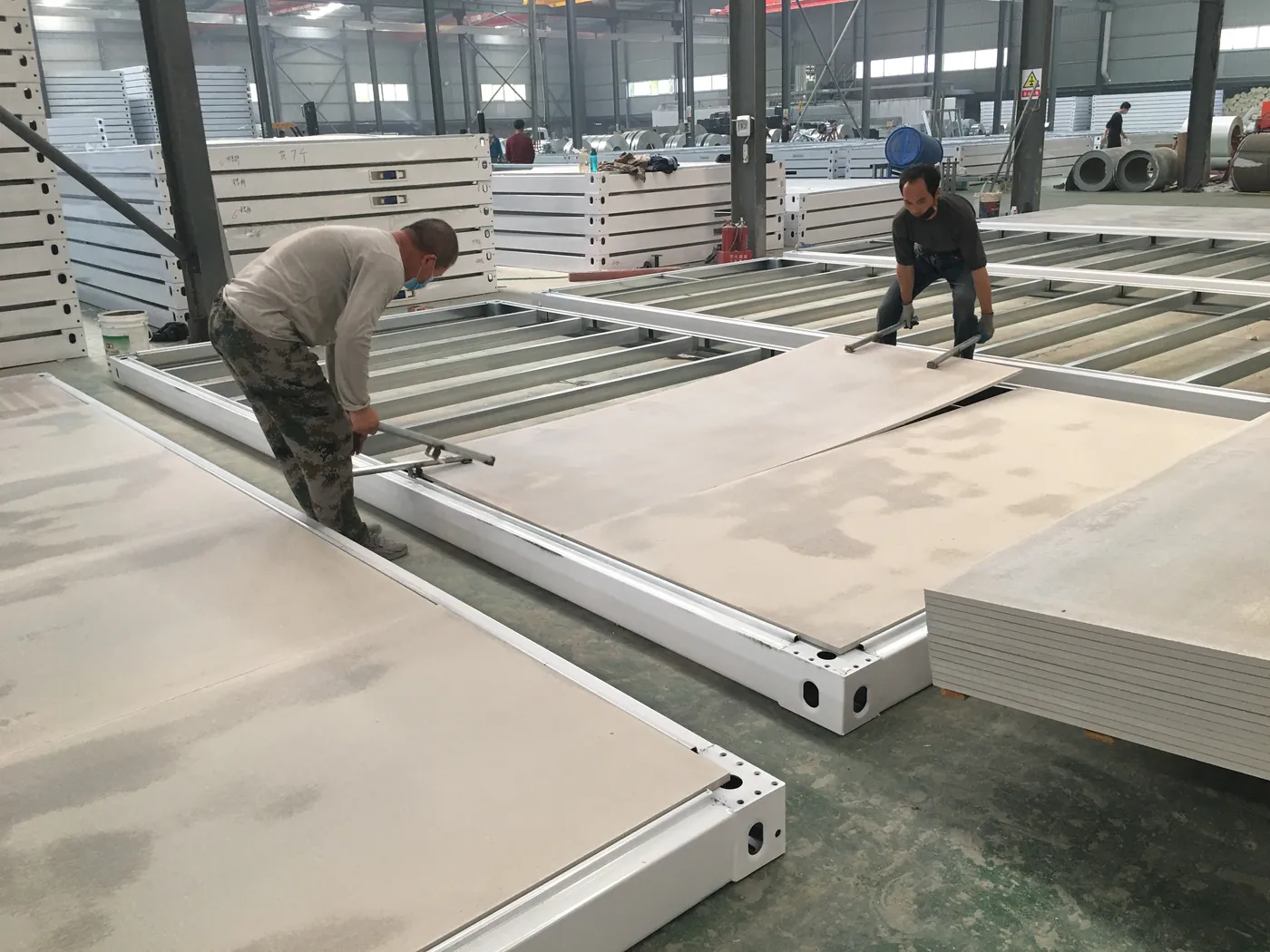 Workers installing floor panels